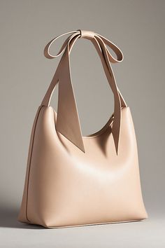 Recycled polyurethane; recycled cotton lining One inner zip pocket One inner magnetic pocket Zipper styling Imported | Bow Midi Shoulder Bag by Anthropologie in Beige, Women's, Cotton/Polyurethane Anthropologie Purse, Confident Outfit, Bow Bag, Evening Handbag, Chic Bags, Purse Styles, Leather Bows, Fashion Icon, Beauty Bag