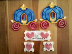 two pieces of bead art on a wooden surface, one has a carriage and the other has hearts