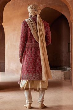 Red full sleeve sherwani, highlighted with all over peacock feather motif embroidery. Paired with a beige monga tussar kalidar kurta and churidar.
Components: 3
Pattern: Embroidery
Type Of Work: Peacock, Thread, Zardozi
Neckline: Stand Collar
Sleeve Type: Full Sleeves
Fabric: Matka Silk and Monga Tussar
Color: Red
Other Details: 
Model height: 6ft, wearing size M
Note: The belt, shawl, footwear and safa worn  by the model is not for sale
Occasion: Destination Wedding,Groom - Aza Fashions Traditional Naqshi Anarkali Set For Ceremonies, Traditional Anarkali Set With Naqshi For Ceremonies, Anarkali Sherwani With Zari Work For Traditional Ceremonies, Ceremonial Anarkali Sherwani In Raw Silk, Ceremonial Anarkali Style Raw Silk Kurta, Traditional Raw Silk Bandhgala With Drape, Long Sleeve Naqshi Traditional Wear In Raw Silk, Anarkali Style Ceremonial Sherwani In Raw Silk, Red Sherwani For Festivals With Straight Kurta Shape