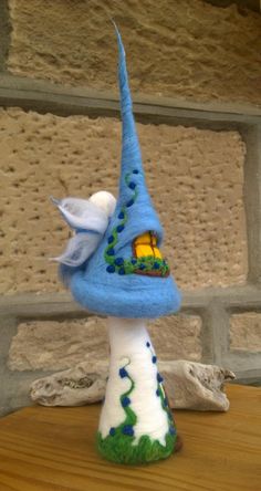 a blue and white gnome hat sitting on top of a wooden table