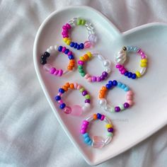 a heart shaped tray with bracelets on it