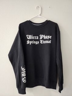 "Wicca Phase Springs Eternal \"task force\" or \"cast spells write checks\" GBC crewneck sweatshirt Handmade to order with heat transfer vinyl ♡ Sizes S-4XL available Select your design: either the abbreviated WPSE front pocket logo with \"cast spells write checks\" on back, or the full wicca phase springs eternal\" font with \"task force\" written on the back Unisex fashion/design but runs in men's sweatshirt sizes, so please take this into consideration when selecting your size! 60% cotton, 40 Wicca Phase Springs Eternal, Pocket Logo, Transfer Vinyl, Crewneck Sweater, Heat Transfer Vinyl, Crew Neck Sweater, Heat Transfer, Unisex Fashion, Front Pocket