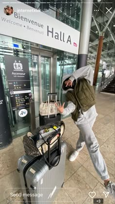 the man is pushing his luggage through the airport