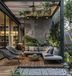 an outdoor living area with furniture and plants