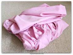 a pile of pink clothes laying on the floor