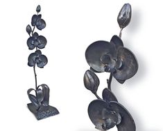 two metal sculptures with flowers and leaves on them, one in the shape of an orchid