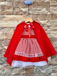 Introducing the Red Hooded Girl Costume: A Stylish Outfit for Special Occasions! Red riding hood dress. Red riding hood costume . for special occasion .Dress your little one in this stunning Red Hooded Girl Costume, a perfect choice for special occasions. The costume features a knee-length design with white striped patterns alongside lace and button details. The skirt is adorned with chic stripes, and the costume is completed with a red hood. Let's explore the details of this unique costume in t Red Princess Costume Dress, Red Halloween Dress For Dress-up, Red Dress For Halloween Dress-up, Cute Red Princess Dress For Dress-up, Fitted Red Princess Costume, Christmas Red Princess Dress For Fancy Dress, Red Princess Costume For Costume Party, Red Princess Dress For Winter Dress-up, Red Princess Costume For Fancy Dress