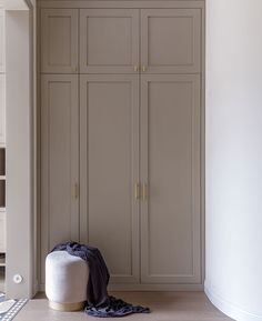 an empty room with some cupboards and a blanket on the floor next to it