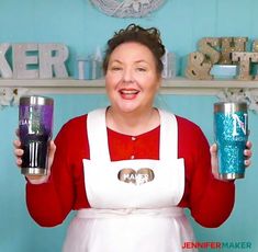 a woman in an apron holding two cups