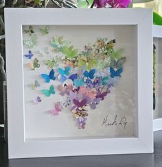 a white frame with many different colored butterflies in it