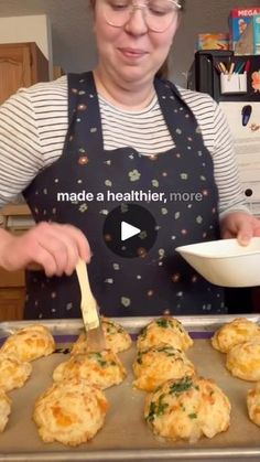 a woman in an apron is cooking some food