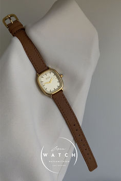 This stylish watch features a square light gold dial with a sleek gold bezel, paired with a comfortable brown genuine leather strap. The minimalist design offers both elegance and versatility, making it perfect for any occasion or style. Women’s Watch, Womens Watches Minimalist, Watch For Women, Stylish Watches, The Minimalist, Brown Gold, Jewelry Inspiration, Leather Watch, Minimalist Design