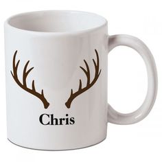 a white coffee mug with two antlers on it's side and the word, christ