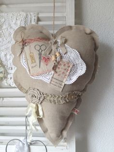 a heart shaped pillow hanging from a wall