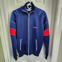 "Vintage Adidas mens zippered track jacket, in excellent condition, with very little wear. Features a YKK zipper, made in Taiwan. Item is likely circa 1980s or 1990s. Size Large.  Measures pit to pit 24\" Measures pit to bottom hem 17\"  Feel free to reach out with any questions. Item ships from Acton, ON, Canada @retro.rewind.vintage" Vintage Crew Neck Track Jacket For Sports, Vintage Cotton Track Jacket For Sports, Vintage Crew Neck Track Jacket For Fall, Retro Crew Neck Winter Track Jacket, Vintage Track Jacket For Streetwear, Vintage Crew Neck Track Jacket For Streetwear, Retro Track Jacket With Three Stripes, Retro Track Jacket With Three Stripes For Streetwear, Retro Streetwear Track Jacket With Three Stripes