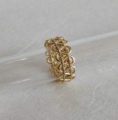 a gold ring sitting on top of a white surface