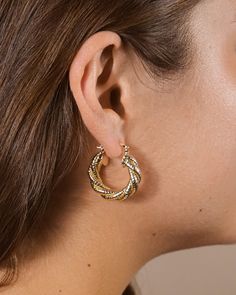 Experience the sophistication and style of Esme Braided Hoops. Crafted with a textured finish and designed to be worn as an everyday accessory, these hoops reintroduce luxury to your everyday wardrobe. Wear with confidence, knowing you're making a statement with your accessories. Material: 14K gold or rhodium plated brass Features: 1.15" hoop, 0.2" width, Lead & Nickel free, friction latch Textured Metal Hoop Earrings For Gift, Chic Textured Metal Earrings, Textured Hoop Earrings For Everyday Wear, Textured Small Hoop Metal Jewelry, Everyday Textured Hoop Earrings, Everyday Small Hoop Textured Earrings, Solid Gold Bracelet, Solid Gold Earrings, Statement Drop Earrings