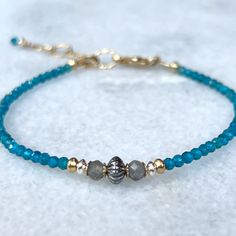 Dainty gemstone bracelet with blue apatite, and labradorite, gold & silver accents beads.  Details~ * All metals used are 14k gold filled and sterling silver, made to last for years to come. * Length: Bracelets are finished with an extender chain, making them adjustable in length. I offer two size options: Sm. 6 1/2 - 7 1/2 inches or Med. 7 1/2 - 8 1/2 inches * Packaging: Your order will arrive  packaged in a gift box, wrapped with a ribbon and ready for gifting. * Please visit my Etsy shop for Blue Labradorite Bracelet As A Gift, Blue Labradorite Bracelet, Blue Labradorite Bracelets With Natural Stones, Spiritual Blue Birthstone Bracelets, Blue Spiritual Bracelets With Birthstone, Blue Apatite Bracelet Jewelry, Bracelet Dainty, Bracelet Ideas, Minimalist Bracelet