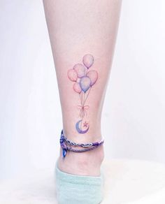 a woman's foot with balloons on it and the word tattoo - mun