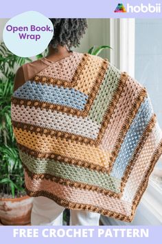 a woman holding up a crocheted blanket with the words open book wrap on it