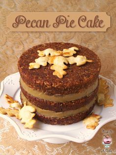 a three layer cake sitting on top of a white plate next to a sign that says pecan pie cake