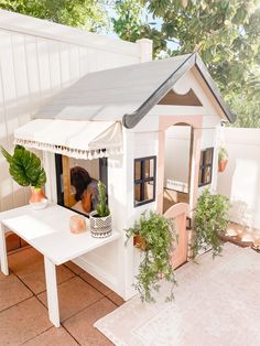 there is a dog in the small house on the table and it looks like he's going to build something