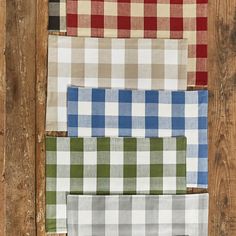 four different colors of plaid fabric laid out on top of each other in various patterns