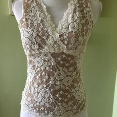 Beautiful Nude Illusion Cabi Lace Tank. Never Worn - No Stains Or Flaws! Elegant Sheer Sleeveless Tank Top, Beige Fitted Lace Tank Top, Sheer Stretch Sleeveless Camisole, Feminine Sheer Sleeveless Camisole, Fitted Sleeveless Lace Blouse, Fitted Sleeveless Lace Top, Sleeveless Stretch Lace Top, Sleeveless Sheer Lace Tops, Fitted Sleeveless Cream Lace Top