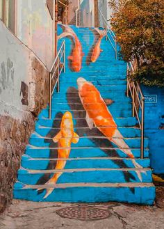 a stair case painted with two koi fish on it's side and the steps leading up to them