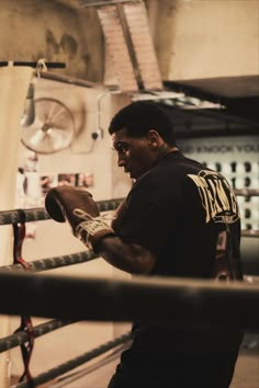 a man standing next to a boxing ring