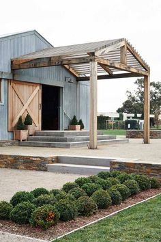 an outdoor patio with steps and planters on the side, surrounded by green grass