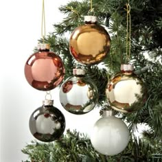 an ornament hanging from a christmas tree with ornaments in the shape of balls