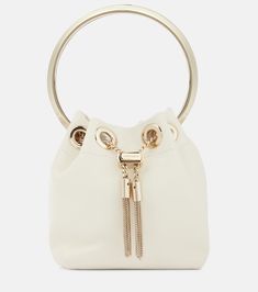 Find Jimmy Choo Bon Bon Micro Leather Bucket Bag on Editorialist. Top handle, Chain shoulder strap. Made in Italy. Designer color name: Latte. Comes with dust bag. Closure: drawstring top. Internal details: leather lining. Material: lamb leather. Trim: brass. Comes with a box. Micro Bag, Classic Bags, Leather Bucket Bag, Leather Bucket, Purple Bags, Womens Designer Fashion, Arm Candy