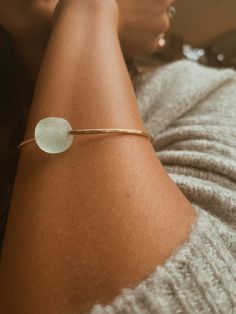 This Seaglass Banle is crafted from beautiful gold filled metal and features a round light blue sea glass bead. With its size of 6,7, or 8” this bangle is perfect for all wrist sizes. It's an eye-catching piece sure to make a statement. Round Light, Bangle Ring, Blue Sea Glass, Blue Sea, Earring Necklace, Sea Glass, Body Jewelry, Necklaces Bracelets, Gold Filled