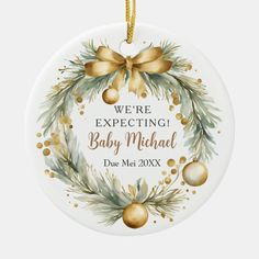 a christmas ornament that says we're expecting baby michael duee in gold