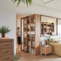 a living room filled with lots of furniture and bookshelves