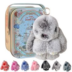 the small stuffed animal is sitting in front of a tin case with several different colors