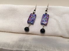 These unique earrings will look great separately, or as part of a set. Elegant Multicolor Plug Earrings For Gift, Handmade Rectangular Earrings For Parties, Artsy Purple Dangle Earrings, Artsy Drop Earrings For Party, Artsy Black Dangle Earrings, Artsy Black Drop Earrings, Purple Abstract, Unique Earrings, Looks Great