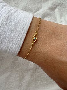 A Handmade bracelet that is made from gold plated from sterling silver 925 with a central charm that is an evil eye in oval shape with a turquoise Cubiz Zirconia . You canselect it in gold or silver color. Find them only at Christina Christi Store.  👉 My Women Bracelets Collection: https://etsy.me/2U57si7 👉 Express Shipping: https://etsy.me/3ikUnOM MATERIALS - Gold 24k Filled Evil Eye from Sterling Silver 925. - Evil Eye is made from cubic zirconia in turquoise color. - All my chains have the Bracelet Evil Eye, Women's Bracelets, Protection Bracelet, Classy Jewelry, Eye Bracelet, Evil Eye Charm, Gold Plated Bracelets, Evil Eye Bracelet, Evil Eye Jewelry