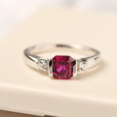 All HANDMADE ITEMS SHIP IN APPROX 8 DAYS Main Stone: Lab created ruby Main Stone Size: Asscher cut 6 mm x 6 mm Main Stone Weight: 1.44 carat Side Stone: Round shaped CZ Height From The Ring Setting Bottom(to gemstone top): about 5.17 mm Width of Ring band Measure: gradually varied,about 2.07-2.79 mm Material: 925 Sterling Silver/14K White Gold/14K Yellow Gold/14k Rose Gold Engraved: Available For FreeNo more than 13 letters) Customized:Of course! Tell me what you want Includes With Order: All of Ruby Silver Rings For Women, Asscher Cut Ruby Jewelry With Center Stone, Ruby Jewelry With Asscher Cut For Anniversary, Formal White Gold Ruby Ring With Birthstone, White Gold Ruby Ring With Princess Cut, Asscher Cut Ruby Ring With Center Stone, Silver Asscher Cut Ruby Jewelry, White Gold Princess Cut Ruby Ring, Ruby Asscher Cut Promise Ring