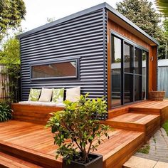 a small house sitting on top of a wooden deck