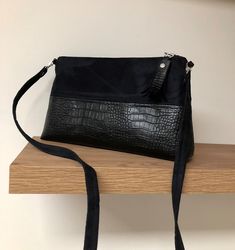 An elegant and timeless black baguette shoulder bag for women, this zippered evening clutch is designed in realistic black suedette and reptile faux leather for shoulder or hand carrying. With its beautiful dimensions, this trendy bag will easily contain your essentials, keys, papers, phone,...etc. Height: 18 cm, length at the base 31 cm, zip length 25 cm, thickness 6 cm. By its design, this bag has a very nice outfit, even empty!  It is fully lined with a printed cotton fabric (You want a parti Black Textured Leather Shoulder Baguette Bag, Black Textured Leather Baguette Shoulder Bag, Black Baguette Clutch Bag With Adjustable Strap, Black Clutch Baguette Bag For Evening, Evening Clutch Baguette Bag With Zipper, Evening Clutch Baguette Bag With Zipper Closure, Evening Baguette Clutch With Zipper Closure, Leather Clutch Evening Bag With Zipper, Versatile Black Clutch Shaped As Shoulder Bag