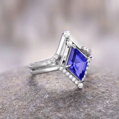 Breathtaking Kite Cut Tanzanite Ring, a mesmerizing symbol of love and commitment crafted with precision and passion. This exquisite ring is meticulously designed with a 925 sterling silver band, showcasing a unique geometric setting that adds a contemporary and elegant touch to the classic engagement ring.►At the heart of this stunning piece is a captivating kite-cut Tanzanite gemstone, renowned for its enchanting purple hue. The vivid and alluring color of Tanzanite is not only a visual feast Lights Trees, Couples Ring, Classic Engagement Ring, Traditional Engagement Rings, Couples Ring Set, Classic Engagement, Tanzanite Ring, Matching Wedding Bands, Tanzanite Gemstone