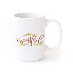 a white coffee mug with the words beautiful written in red and gold lettering on it