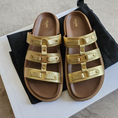 Celine Tippi Triomphe Slide Sandals Gold Metallic Leather Size: 37 Worn With Care Once For A Daytime Birthday Brunch & Has Been Stored Safely In It's Original Box Since Color: 35or Gold Line: Tippi Laminated Calf Skin Model: Triomphe Mule 30 Heel Height: Low (1-1.9 Inch) Insole: 10.5" Exterior Sole: 11.25" Specific Heel Height: 1.5" Sku: 352343093c.35or Made In Italy Retails For $990 Designer Gold Leather Sandals, Chic Gold Leather Sandals, Luxury Gold Leather Sandals, Luxury Gold Sandals With Leather Sole, Designer Gold Sandals With Round Toe, Designer Gold Flat Sandals, Chic Gold Sandals In Calf Leather, Chic Gold Calf Leather Sandals, Chic Gold Sandals With Leather Sole