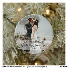 a christmas ornament hanging from a tree with a bride and groom on it