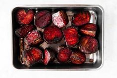 roasted beets in a roasting pan on a white surface