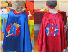 two children dressed up as superheros at a birthday party, one in blue and the other in red