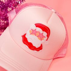 Star Eye Santa Trucker Hat! This pink hat features the cutest Santa glammed out with star eyes! This preppy Santa hat is perfect for the holiday season! The best gift for a bestie who loves trucker hats and Santa! This trucker hat is the best winter accessory! Complete your cozy look with this hat! Treat yourself or your bestie to this adorable hat! A unique accessory to make any outfit stand out! Spread the holiday cheer with this pink hat! This funky santa is just what you need for holidays! T Pink Baseball Cap Mini Hats For Party, Pink Mini Baseball Cap For Parties, Pink Novelty Mini Hats For Gifts, Pink Novelty Winter Hats, Pink Novelty Mini Snapback Hat, Pink Trucker Hat As Gift, Pink Trucker Baseball Cap For Gift, Pink Trucker Baseball Cap As A Gift, Pink Snapback Baseball Cap For Party