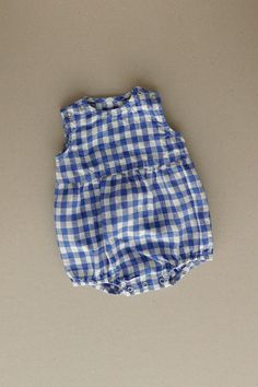 Product photos - blue gingham. The model is wearing a romper in yellow gingham. All-day comfort is guaranteed with this sleeveless romper crafted from medium-weight linen. The fabric is soft, breathable, and light on the skin. For simple changing, the romper is designed with popper snap fastenings on the shoulders and bottom. The waist seam in the middle adds a nice final touch to an adorable silhouette, and elasticated leg cuffs secure the romper in place. This baby romper is designed to be comfortably loose-fitting and allow for growth as the baby grows. Summer Gingham Cotton Bubble Romper, Plaid Cotton Bubble Romper For Summer, Summer Cotton Plaid Bubble Romper, Summer Plaid Cotton Bubble Romper, Cute Gingham Bubble Romper For Spring, Blue Bubble Romper For Summer, Cute Spring Gingham Bubble Romper, Cute Gingham Cotton Bubble Romper, Cute Cotton Gingham Bubble Romper